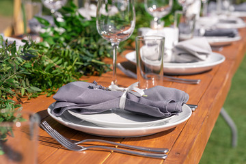 Preparing for an open-air party. Decorated with fresh flowers served tables. Table number. Decoration Details