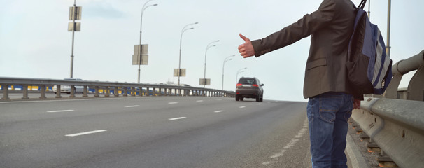 Man hitching a ride on the road. Travel. Divorce. Escape. Immigration.
