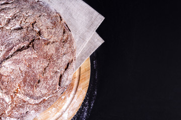 Top view of fresh soft homemade rye bread. Close-up. Delicious low carb round bread just from the bakery on wooden board. Copy space.