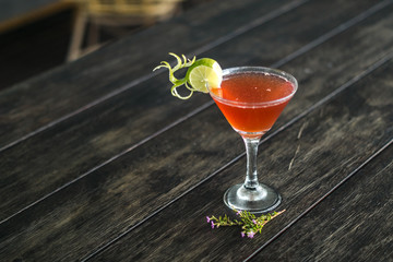 Red cocktail created from a mixture of strawberries and lime.