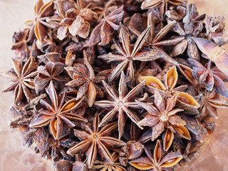 Top view of dried herbs and spices with whole aromatic brown badia star anise or Illicium verum on wooden table.