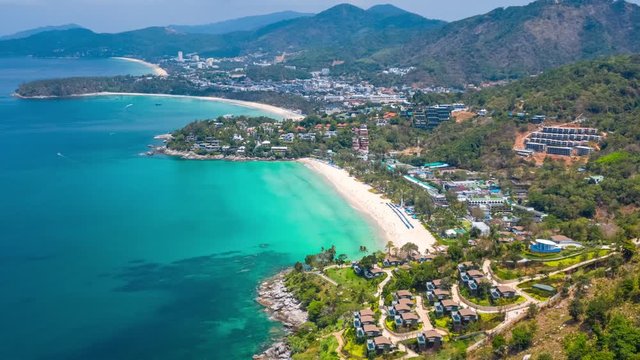 Aerial hyperlapse of the coast of Phuket island in Thailand. Flight over the beaches of Kata Noi, Kata and Karon during the sunny day with clouds in the sky. Timelapse of the tropical island of Phuket