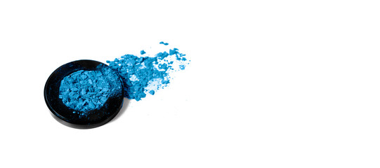 Crushed classic blue eyeshadow palette texture. Classic blue palette makeup powder swatch isolated on white background. Horizontal view copyspace.