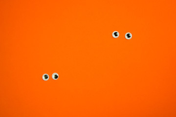plastic pair of eyes on a bright background, place for text, minimalism concept