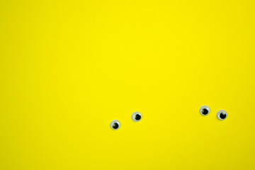 Fototapeta premium plastic pair of eyes on a bright background, place for text, minimalism concept