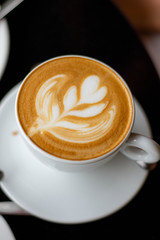 Top view of hot coffee latte with latte art