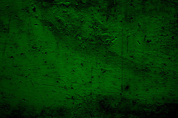 Dark green cement texture background. Dark green surface with cracks, small holes and scratches. Close-up, horizontal, top view, plenty of free space for text.