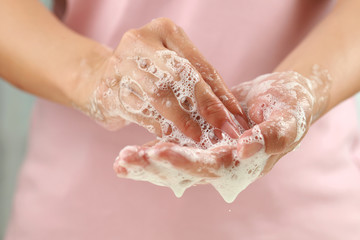 Close up female washing hand with soap. Good personal hygiene practices.