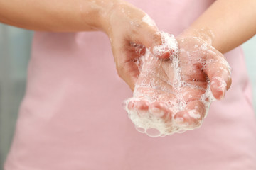Close up female washing hand with soap. Good personal hygiene practices.