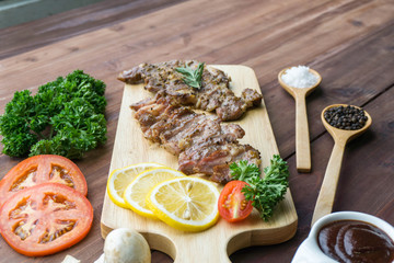 Close up grilled beef steak on wooden cutting board