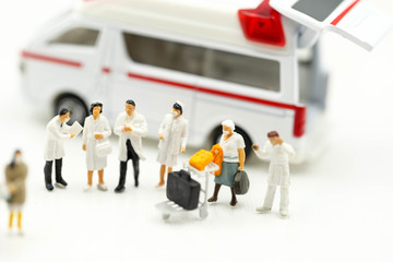 Miniature people : Doctor team with Ambulance, coronavirus covid 19 infected patient caution outbreak alert.