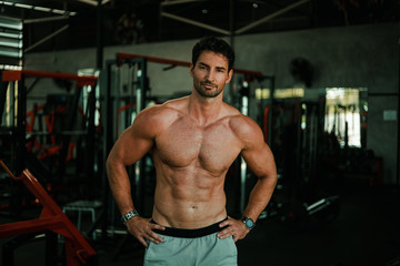 Fototapeta na wymiar Handsome Man exercise in gym body-building with muscular strong body