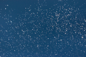 clear and fuzzy drops of water on a blue background