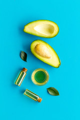 Avocado oil - ingredient for cosmetics - on blue background top-down
