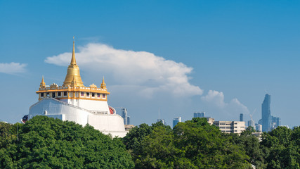 The scenery of Wat Phu Khao Thong (Golden Mount) or Wat Saket temple and Mahanakhon building in Bangkok, Thailand.