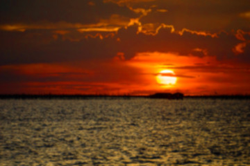 Naklejka na ściany i meble Blurred sunset on the sea