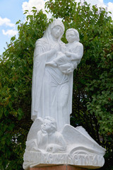 Russia, Kazan June 2019. Statue of a woman with a baby in her arms made of white stone. Christian sculpture. Religious stone statue.