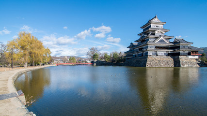 Reflection of Matsumoto castle in a good weather day, Nagano, Japan.