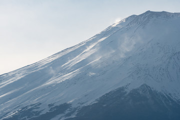 Fototapeta premium Closeup view of the peak of Fuji mountain covered with snow.