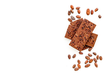 Chocolate - stack of dark bars - on white background top-down copy space