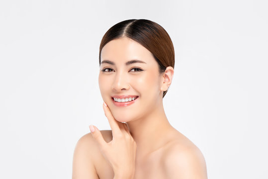 Youthful pretty Asian woman with hand touching face on white background for beauty and skin care concepts
