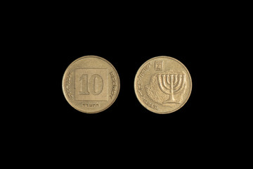 ten Israeli agorot 2010 from both sides on a black background. Close-up
