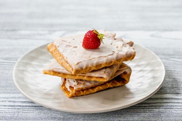 Waffles and strawberries on a grey wooden background. Dessert with berries
