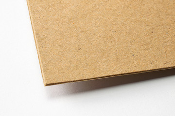 Blank craft textured cardboard paper corner macro view selective focus on white as template for...