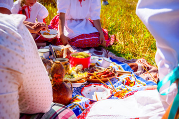 Children are having breakfast at traditional wheat harvest