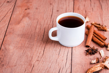 Fragrant natural coffee with cinnamon sticks and a black spoon.
