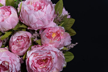 Beautiful bouquet of pink peonies . Floral composition on black background.