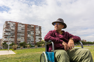 Man in wheelchair taking a walk in the park