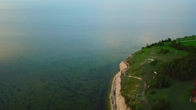 aerial view of the ocean in saare county besides the cliff on the afternoon