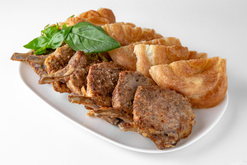 Rack of lamb, or rabbit shoulder blade, pork ribs with plasters. Banquet festive dishes. Gourmet restaurant menu. White background.