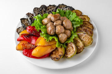 Grilled vegetables appetizer: zucchini, eggplant, tomatoes and peppers. Banquet festive dishes. Gourmet restaurant menu. White background.