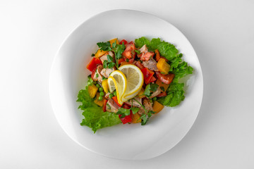 Salad of vegetables, meat and cheese with sauces. Banquet festive dishes. Gourmet restaurant menu. White background.