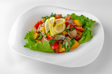 Salad of vegetables, meat and cheese with sauces. Banquet festive dishes. Gourmet restaurant menu. White background.