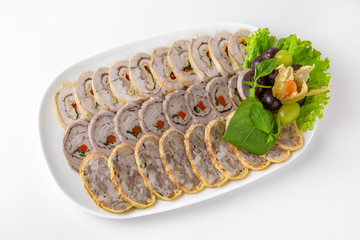 Sliced meat delicacies. Delicious beef, pork and poultry rolls stuffed with dried fruits and pastes. Banquet festive dishes. Gourmet restaurant menu. White background.