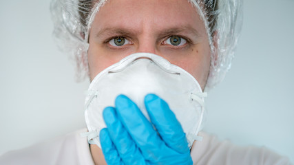 Man holding face mask. Protective raspiratory mask for spreading coronavirus
