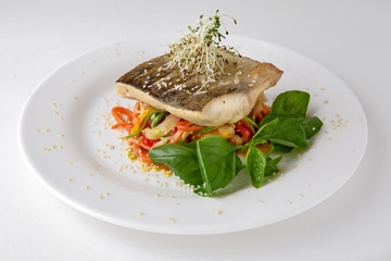 Tender dorado fillet with vegetables and basil. Banquet festive dishes. Gourmet restaurant menu. White background.