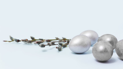 Easter eggs on the table with willow. Design concept.