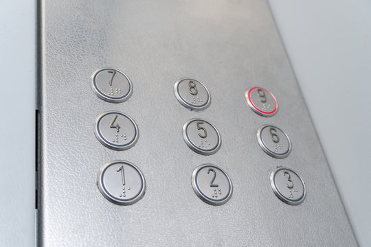 Elevator buttons with Braille, the system highlights the button for the 9th floor