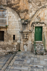 Fototapeta na wymiar Old buildings in a Coptic part of the complex of the Basilica of the Holy Sepulchre in Jerusalem