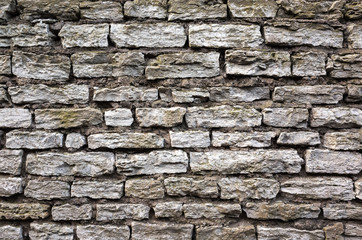 Old grungy gray brick wall, front view texture