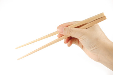 Hand holding bamboo chopsticks isolated on white