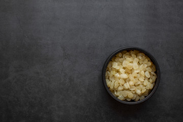 chinese dessert tong sui(Sweet Soup)ingredients ;Chinese cuisine, dried saponin rice on dark gray background, health food,a traditional food.