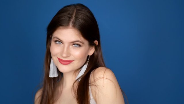 Portrait of a girl in the studio on a blue background.
