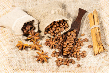 roasted coffee beans with cloth sack on wooden texture