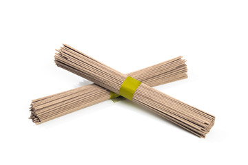 Dried raw japanese soba noodle sticks isolated on a white background. - Image