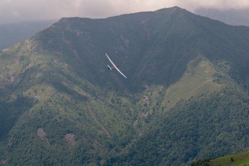 Model of an airplane flying over Bielmonte's mountains